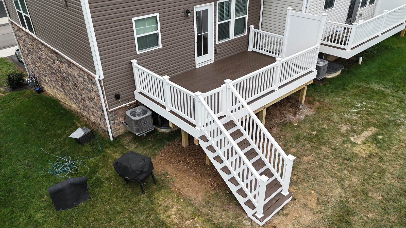 TimberTech deck extension with white RDI square balusters and privacy gate in Adams Township PA