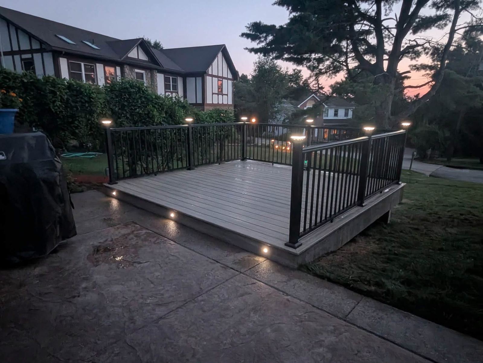 Trex deck at twilight with RDI inlay deck lighting along the railing posts and stair risers, Allison Park PA
